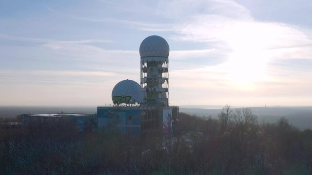 abandoned observatory station on a hill in winter during sunset
