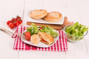 Puff pastry filled with tomato and mozzarella cheese.