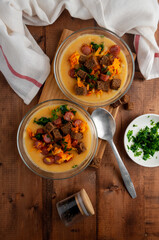 Lentil soup with croutons, sausages and herbs