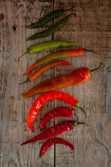 Red and green chili peppers on a wooden gray background