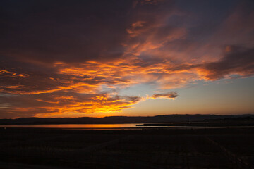 Fototapeta na wymiar 潟湖を照らす美しいオレンジ色の夕日 | 福島県相馬市の松川浦