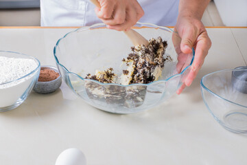 Woman hands making preparation for baking chocolate chip cookies