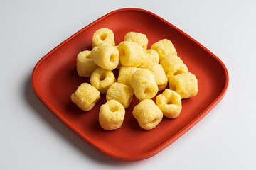 Crispy Corn rings salty snacks. Fast food or junk food snacks unhealthy concept.
