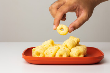 Crispy Corn rings salty snacks. Fast food or junk food snacks unhealthy concept.