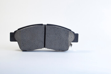 Brand new brake pads for a car on a white background. Brake pad - part of the brake system and its...