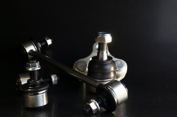 A completely new set of spare parts for the chassis of the car, the stabilizer bar of the car, the ball joint. Car parts on black background