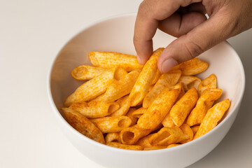 Crispy penne pasta shaped salty. Fast food or junk food snacks unhealthy concept.