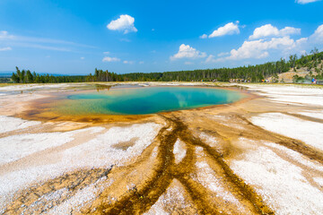 Turquoise Pool in Midway Geyser Basin has milky, white bottom and gem-like, blue-colored water....