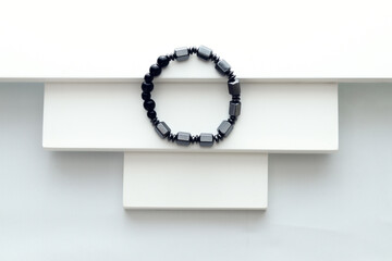 Round natural black stone bracelet on white  background, healthy stone bracelet
