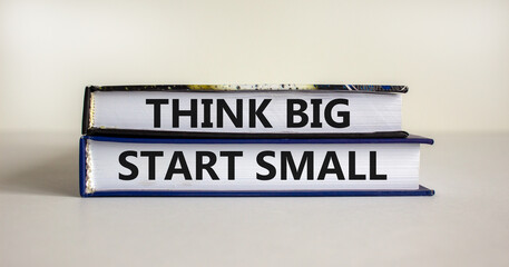 Think big start small symbol. Concept words 'Think big start small' on books on a beautiful white background. Business, motivational and think big start small concept.