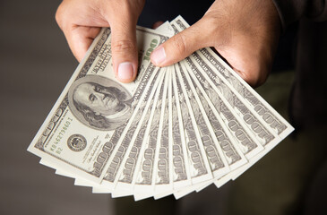 Close up male hand Counting money us dollar. Financial business concept.