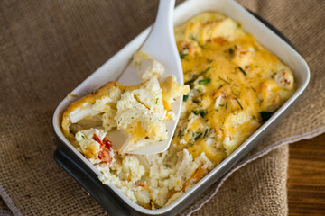 baked cauliflower with chicken fillet and vegetables topped with cheese