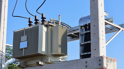 Close up the transformer on a concrete pole. Three-phase transformers and rafts on rails for...