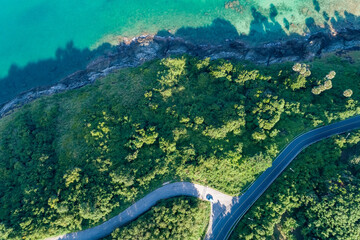 Aerial view top view seashore with asphalt road curve in Tropical island Amazing nature view Beautiful island in Phuket Thailand