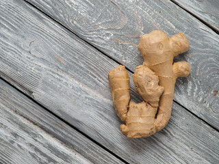 Ginger root on wooden background.