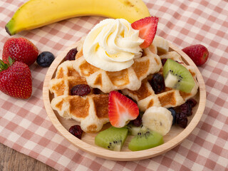 Plate of waffles with  fresh  fruits
