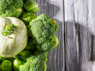 Different types of cabbage on wooden background.