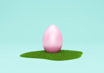 Pink Easter Egg on Green Grass on turquoise studio background