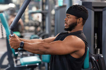 Side view of bodybuilder working out on pec deck machine