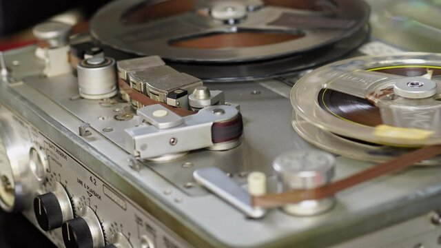 Old vintage reel-to-reel player. Tape recorder with spools. Bobbin tape recorder.	
