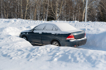 Car in a parking lot under the snow. Russia