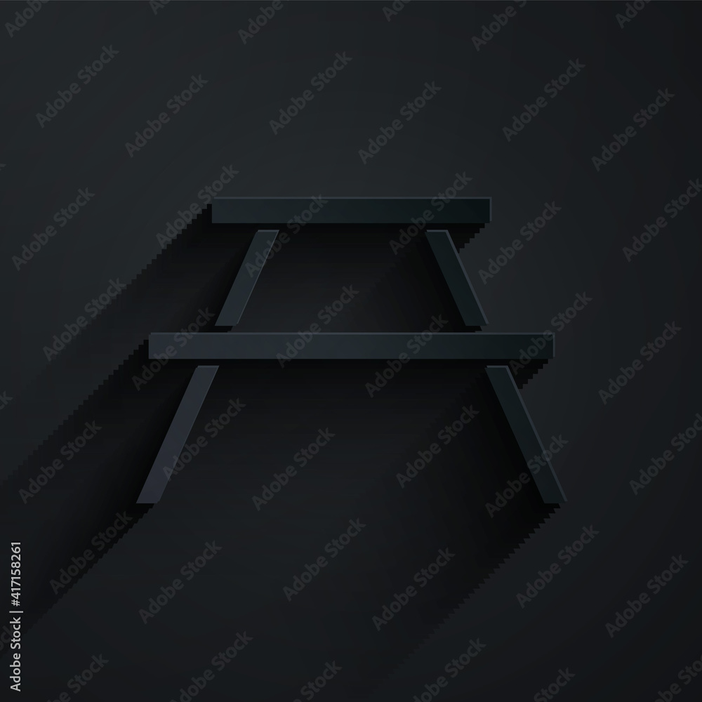 Poster paper cut picnic table with benches on either side of the table icon isolated on black background. p