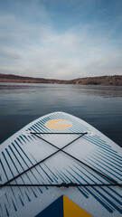 The front of a stand up paddle board on a lake (Lake Mead) in Nevada, USA