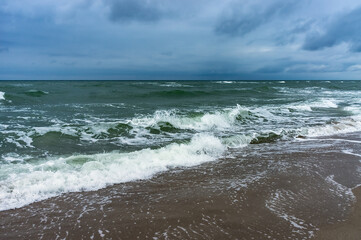 Fototapeta na wymiar The sea is agitated. Huge waves of the sea. Cloudy landscape on the sea.