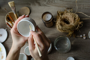 Hand-painting homemade ceramic dishes.