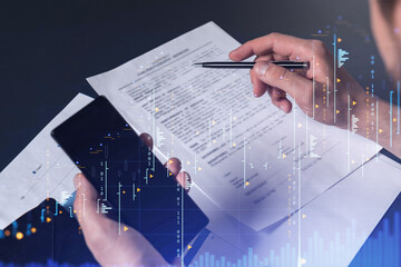 A client in casual wear is signing the contract to invest money in stock market. Internet trading...