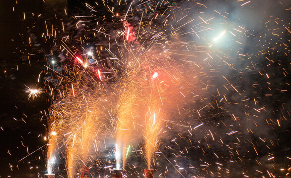 Celebrating the holidays at night with bright fireworks and sparklers