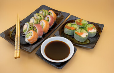 Close up of Japanese sushi roll with salmon avocado soy sauce and chopsticks
