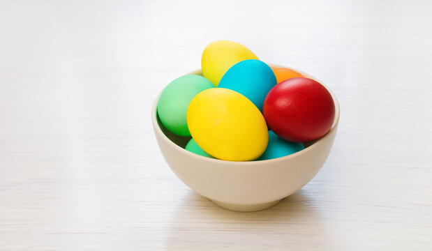 Multicolored easter eggs in bowl close up