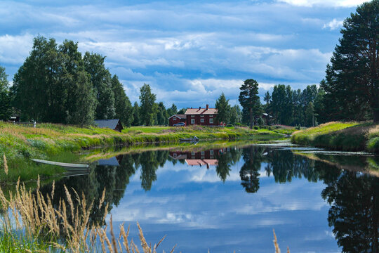 Landscape with a red house and a lake in Malung, Dalarna, Sweden