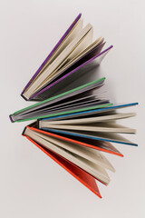 new books of different colors on white background