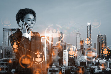 Attractive black businesswoman developer having conference call to protect clients confidential information by inventing solutions. social media icons over Bangkok city background.
