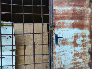 rusty iron door. old rusty door and lattice from fittings