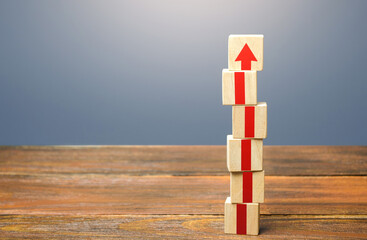 Block tower with red arrows. Growth, development and progress concept. Career promotion step by...