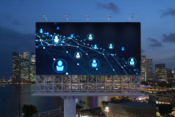 Glowing Social media icons on billboard over night panoramic city view of Singapore. The concept of networking and establishing new connections between people and businesses in Southeast Asia