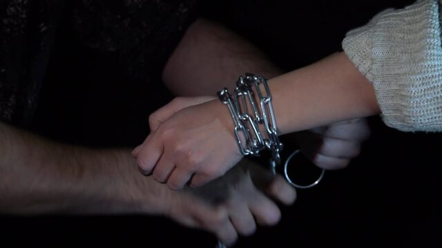 ties the girl with chains. kidnapping of a girl.