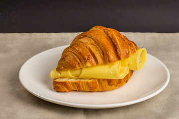 Breakfast with croissant selective focus neutral background
