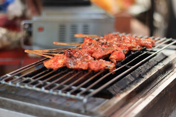 Toast the red chicken on the grill Street food in thailand.