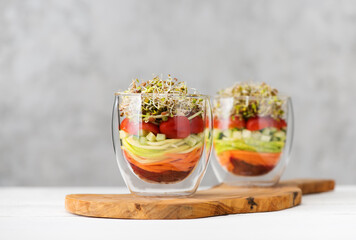 Salad in glass with microgreens and fresh vegetables. Healthy food, clean eating and vegetarian concept