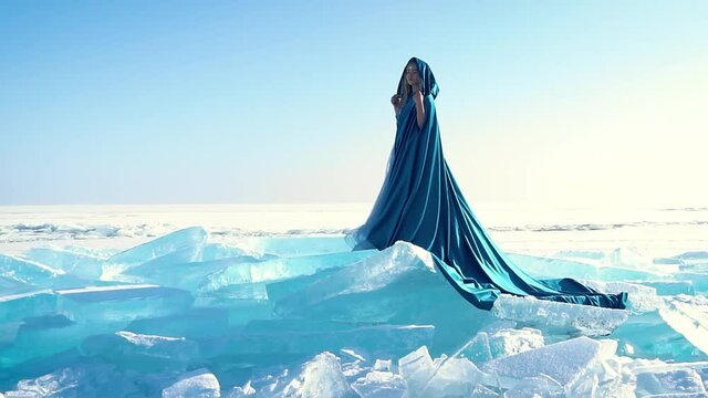 beautiful girl in a blue dress on ice. The Snow Queen. The Snow Queen. beautiful girl on ice. frozen sea. winter's tale