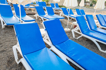 Chairs on the sandy beach near the sea