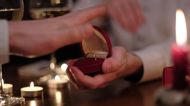 Unsuccessful Gay Couple Engagement. Man partner rejects the groom's offer to marry pushing back the wedding ring