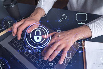 A programmer is typing a code on a keyboard to protect a cyber security from hacker attacks and...
