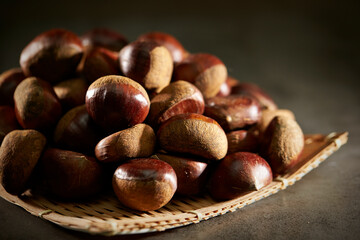 Fresh chestnuts on dark background 