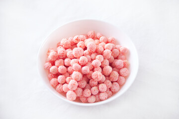 bowl with strawberry sweet corn balls. Delicious and healthy breakfast cereal.
