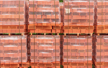 A stack of red sealed bricks. Insulated building bricks.